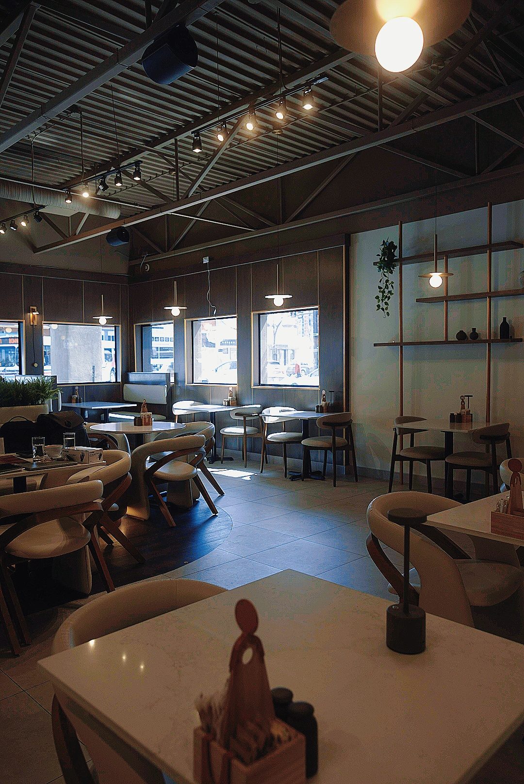 Bright café interior with pale tables and timber detailing